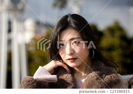 Cityscape and young woman Cityscape and young woman 125390855