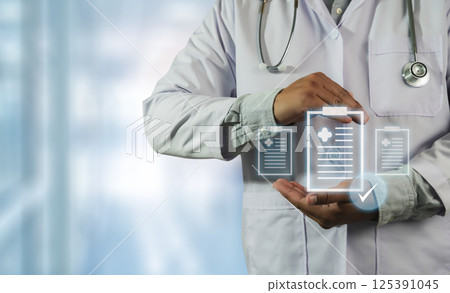 A doctor paper with a check mark on it. The tablet is displaying a medical record A doctor paper with a check mark on it. The tablet is displaying a medical record 125391045