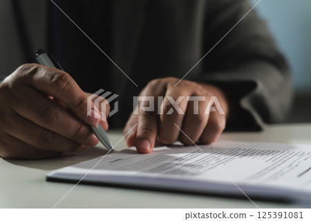businesswoman signing document On Contract Paper reading and checking financial documents businesswoman signing document On Contract Paper reading and checking financial documents 125391081