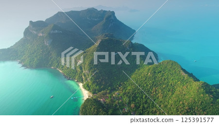 Aerial drone footage of Moo Koh Ang Thong National Marine Park showing turquoise water and green rainforest covering islands in Gulf of Thailand, Southeast Asia during a sunny summer day Aerial drone footage of Moo Koh Ang Thong National Marine Park showing turquoise water and green rainforest covering islands in Gulf of Thailand, Southeast Asia during a sunny summer day 125391577