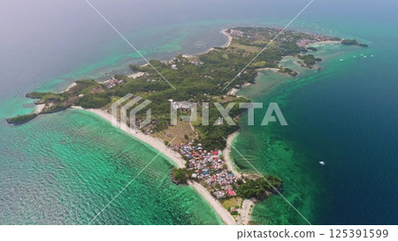 Aerial view of Malapascua Island in the Philippines, featuring vibrant turquoise waters, lush tropical vegetation, and colorful houses along the picturesque coastline Aerial view of Malapascua Island in the Philippines, featuring vibrant turquoise waters, lush tropical vegetation, and colorful houses along the picturesque coastline 125391599