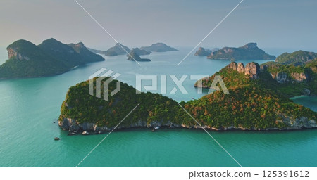 Aerial view capturing Mu Ko Ang Thong National Marine Park, an enchanting archipelago of 42 islands with stunning limestone cliffs and crystal-clear turquoise waters 125391612