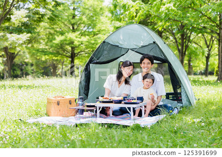 Friendly family enjoying cooking at camp, outdoor image 125391699
