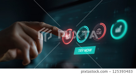 hand is pointing at digital screen with interactive icons and Try Now button 125393483