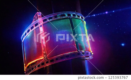 Neon film strip glows vibrantly against a cosmic background during nighttime 125393767