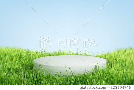 Circular Platform in Green Grass Under Blue Sky 125394746