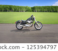 Motorcycle running through green grassland 125394797