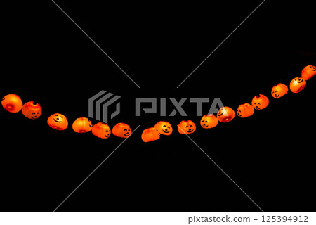 Halloween Decoration Pumplin head light smiling in the dark black background Halloween Decoration Pumplin head light smiling in the dark black background 125394912