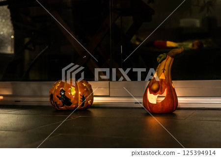 Halloween Decoration Pumplin head light smiling in the dark black background 125394914