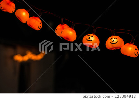 Halloween Decoration Pumplin head light smiling in the dark black background Halloween Decoration Pumplin head light smiling in the dark black background 125394918
