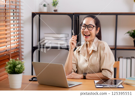 Young asian business woman using laptop for success in modern home office. Young asian business woman using laptop for success in modern home office. 125395551