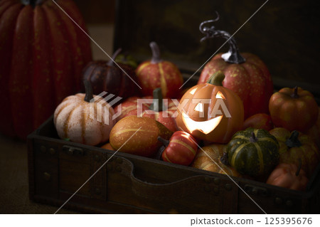 Pumpkins stuffed into an old trunk - Halloween image Pumpkins stuffed into an old trunk - Halloween image 125395676