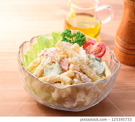 Macaroni salad served in a transparent bowl 125395733