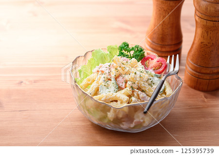 Macaroni salad served in a transparent bowl Macaroni salad served in a transparent bowl 125395739