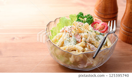 Macaroni salad served in a transparent bowl Macaroni salad served in a transparent bowl 125395740