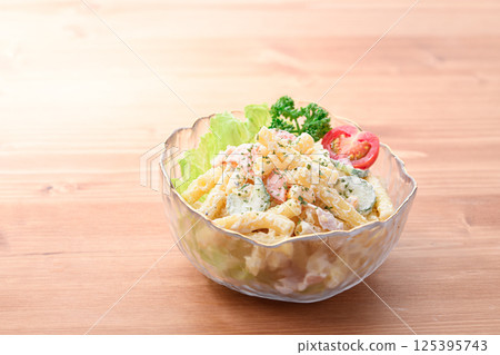 Macaroni salad served in a transparent bowl 125395743