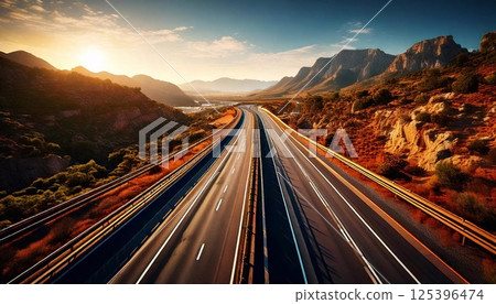 Scenic highway stretches through mountains during sunset in a beautiful landscape 125396474