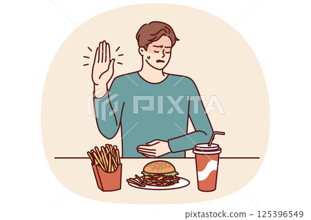 Man suffering from gastritis refuses fast food that causes pain in abdomen on advice of nutritionist 125396549