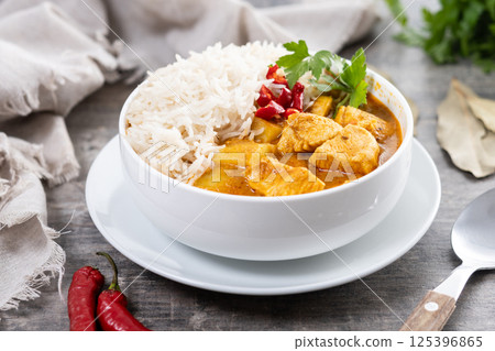 Massaman curry in bowl on wooden table. Traditional Thai food recipe. Massaman curry in bowl on wooden table. Traditional Thai food recipe. 125396865