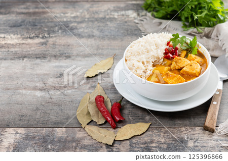 Massaman curry in bowl on wooden table. Traditional Thai food recipe. Massaman curry in bowl on wooden table. Traditional Thai food recipe. 125396866