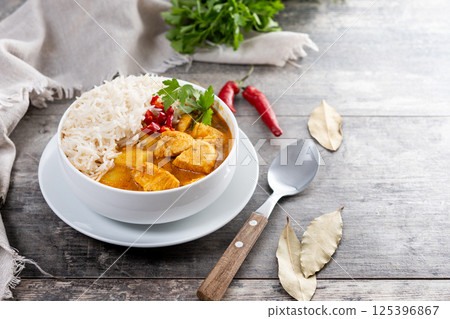 Massaman curry in bowl on wooden table. Traditional Thai food recipe. Massaman curry in bowl on wooden table. Traditional Thai food recipe. 125396867