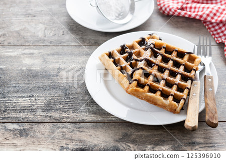 Belgian Waffles with chocolate on wooden table 125396910