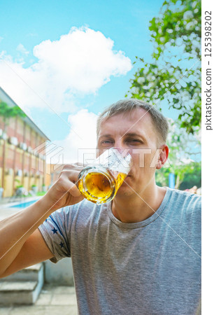 Man is drinking beer Man is drinking beer 125398202