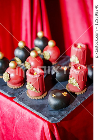 cake, sweets in the shape of perfume bottles and candles 125398240