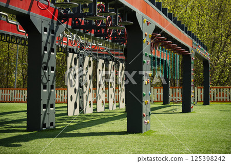 Sports ground outdoors for kids and adult. Successful training concept. Open air gym, street workout concept. Hanging monkey bars on kids playground. 125398242