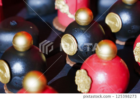 cake, sweets in the shape of perfume bottles and candles 125398273