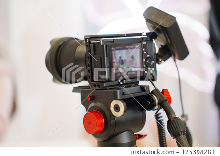 A professional black camera for taking photos and videos at the holiday. A professional black camera for taking photos and videos at the holiday. 125398281