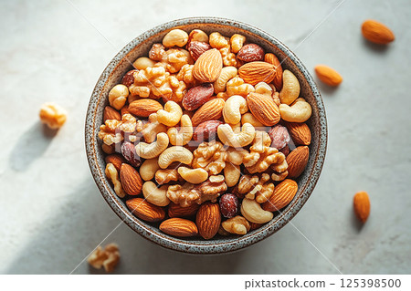 Healthy mix of almonds, walnuts and cashews in a bowl. 125398500