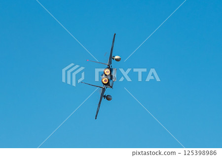 Aggressor demonstrating maneuvering skills at an air show Aggressor demonstrating maneuvering skills at an air show 125398986