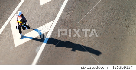 Aerial view of marathon runner in motion on urban road 125399134
