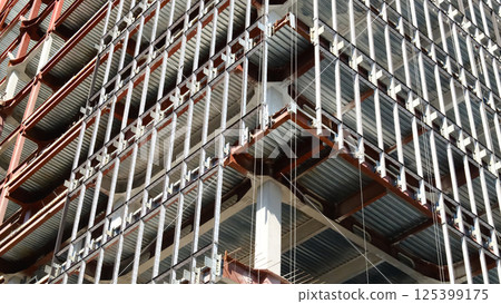 Construction site showing modern building framework with exposed steel beams Construction site showing modern building framework with exposed steel beams 125399175