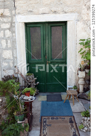 Mediterranean house with green door and flowers in Prcanj, Montenegro 125399274