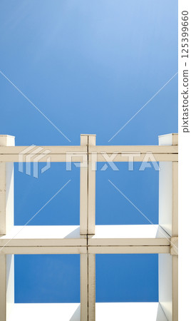Symmetrical architecture roof minimalist grid pattern against deep blue sky with copy space background Symmetrical architecture roof minimalist grid pattern against deep blue sky with copy space background 125399660