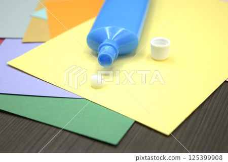 Colored construction paper and a tube of glue 125399908