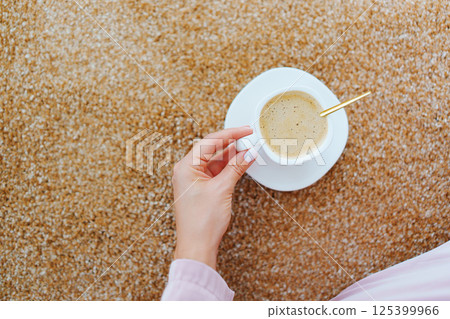 close-up. a cup of coffee on the beige Interior pile carpet. close-up. a cup of coffee on the beige Interior pile carpet. 125399966
