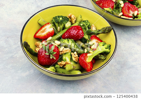 Vegan salad of green asparagus, strawberries. Vegan salad of green asparagus, strawberries. 125400438