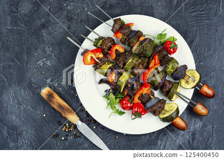 Barbecued meat with garnish. 125400450