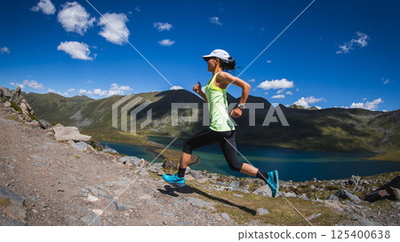 Fitness woman runner running at beautiful mountain top Fitness woman runner running at beautiful mountain top 125400638