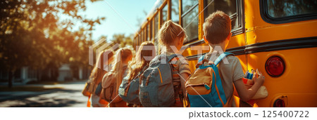 In the warm morning sun, a group of joyful children, backpacks and lunchboxes in hand, excitedly board the bright yellow school bus, captured in energetic, banner In the warm morning sun, a group of joyful children, backpacks and lunchboxes in hand, excitedly board the bright yellow school bus, captured in energetic, banner 125400722