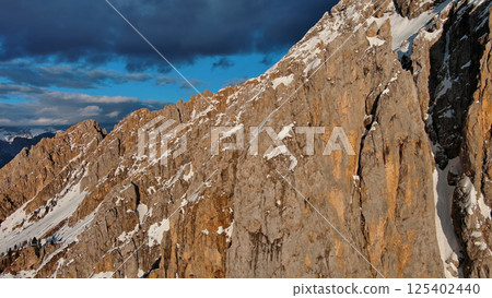 Rocky snow mountains at sunset aerial Rocky snow mountains at sunset aerial 125402440