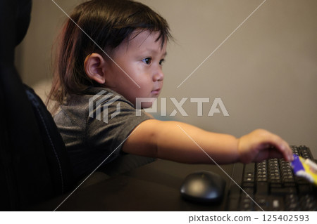 Boy Playing On Computer At Home, Background for advertising and wallpaper in education and work scene. Boy Playing On Computer At Home, Background for advertising and wallpaper in education and work scene. 125402593