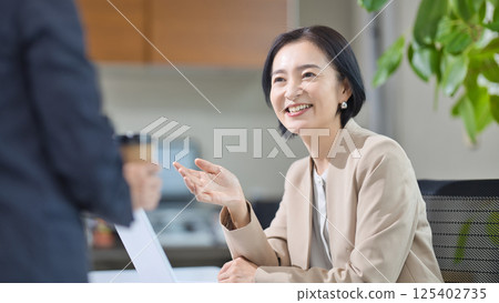 Middle-aged woman having a meeting in the office 125402735