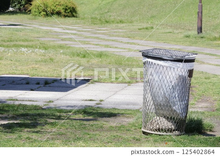 Empty trash can in the park Empty trash can in the park 125402864