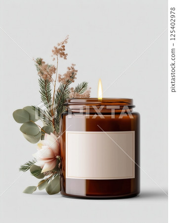 Amber jar candle mockup decorated with flowers and plants, creative design preview template for candle branding, organic scented candle with decor 125402978