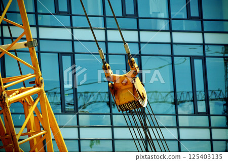 glass office building blue architecture office district crane machine windows reflection 125403135