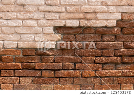 Contrast of Painted and Exposed Brick Wall 125403178